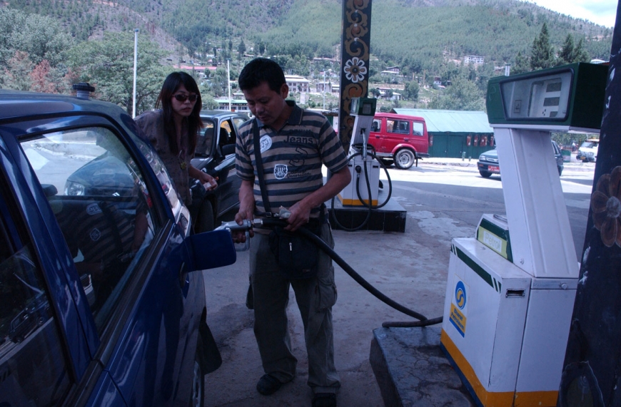 BHUTAN WOMAN PETROL STATION HIGH OIL PRICE